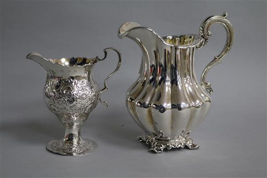 A George III silver inverted pear shaped cream jug, London, 1773 and a Victorian silver cream jug.